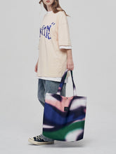 Sac à bandoulière en toile contrastée abstraite